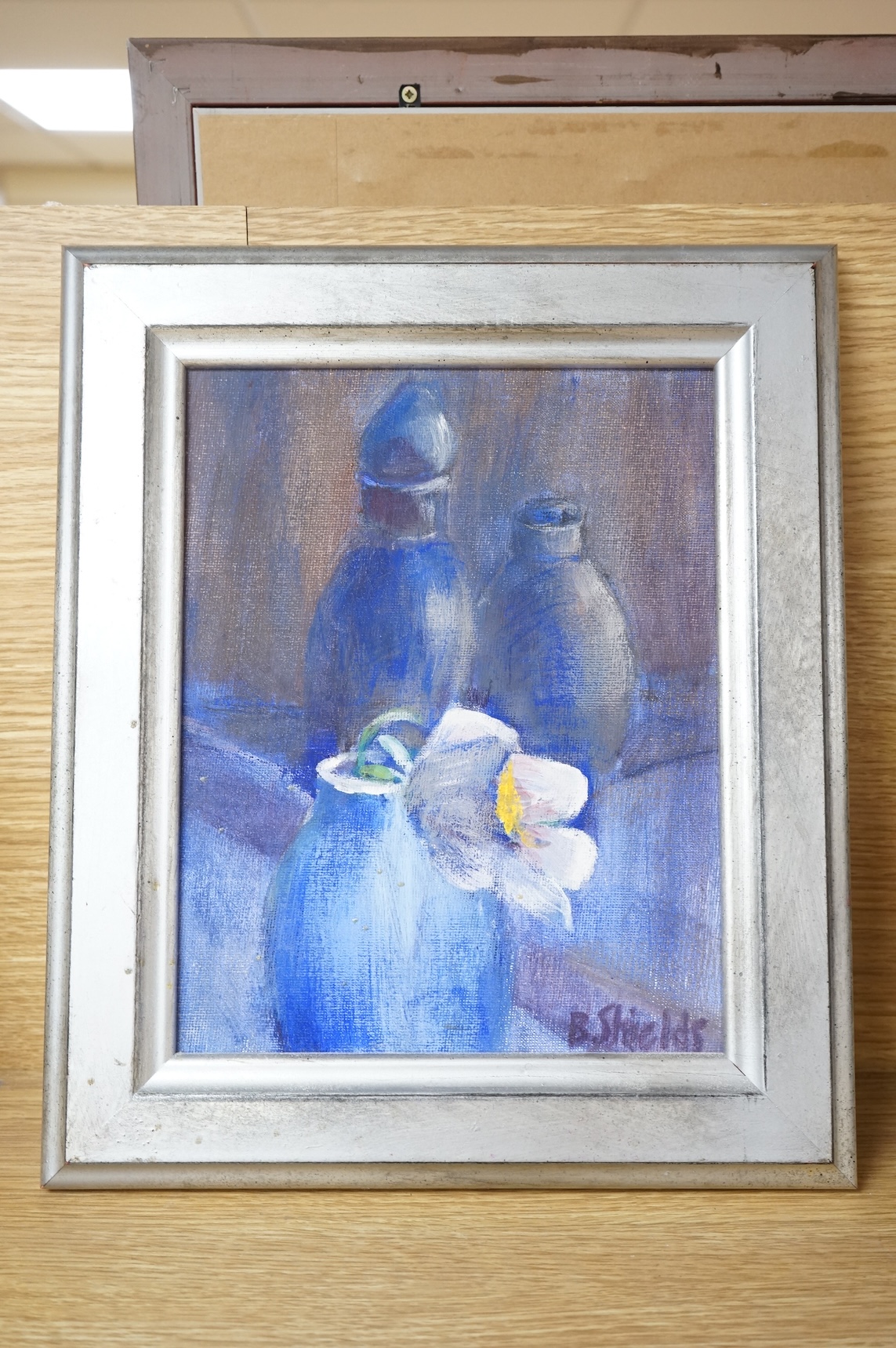 B. Shields, Still life of cornflowers, signed, oil on canvas, together with another, titled 'White flower in blue pot, tempura on canvas board, largest 30 x 24cm, one unframed